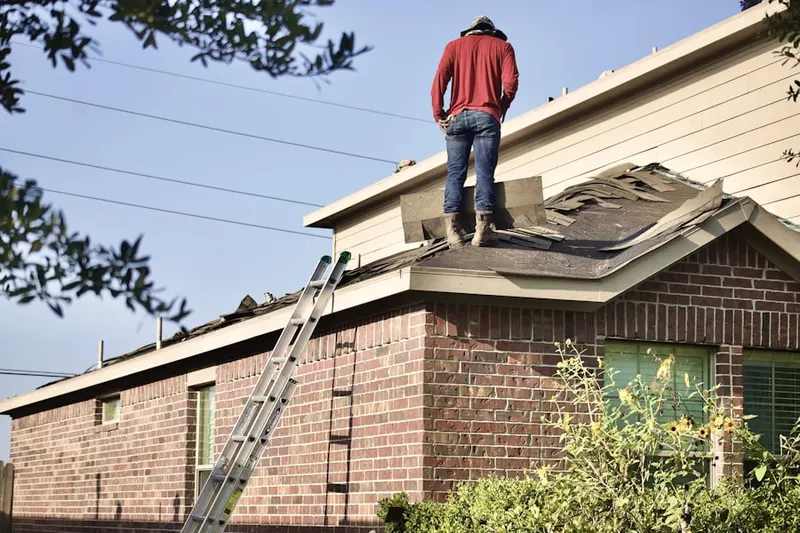 Professional roofer working on a residential roof in Killingly Center